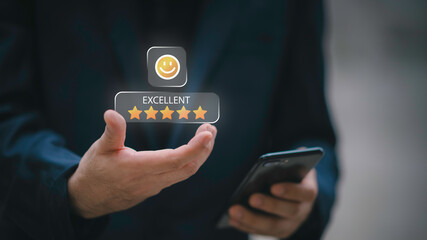 Businessman using smartphone to give five-star positive review with smiley face icon, Customers give 5-star reviews,symbolizing excellent customer feedback, and user satisfaction in digital service.