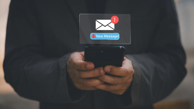 Businessman touching new message notification icon on virtual screen,email alert, online messaging system, representing digital communication, instant response, and business connectivity.