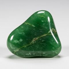 Detailed macro shot of a polished green jade stone with subtle color variations.
