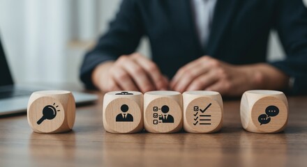 Business Strategy Icons: Conceptual shot of a business person interacting with wooden blocks, each adorned with a distinct icon representing stages of a strategic plan.