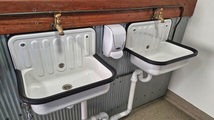 Two hand basins in a utility room , commercial bathroom