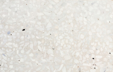 Bright terrazzo floor texture with white and gray marble chips creating a stylish decorative surface. Ideal for modern architecture, minimal design, or background use.