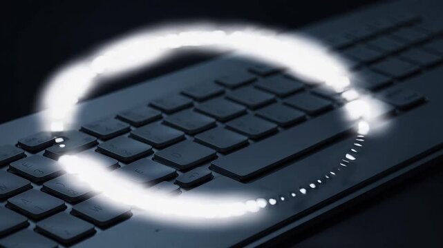Glowing circular light pulse and ring effect floats above computer keyboard, futuristic digital technology innovation, modern workspace with
