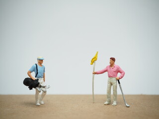 Mini toy of action figure at table with blurred background. Miniature photography concept design. Golf player concept.