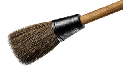 A traditional wooden handled paint brush with natural bristles and a metal ferrule rests against a dark surface