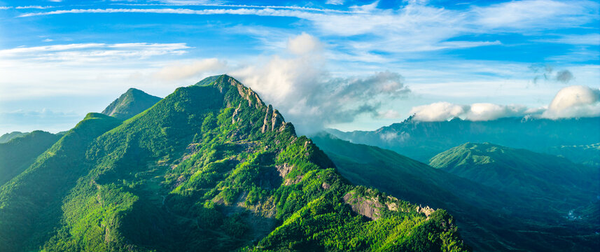 Panoramic view of the majestic green mountain range and forest natural landscape in the morning