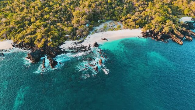 Wide aerial drone video of remote coastline in Lembata, Indonesia, showing forests and hidden beaches.