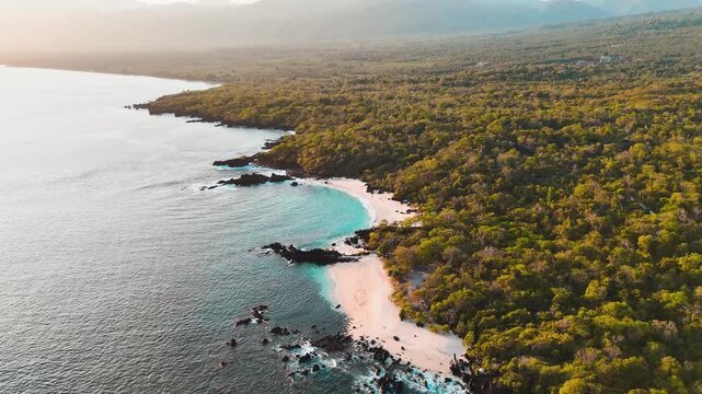 Aerial drone view of Ina Burak Beach in Lembata, Indonesia, with turquoise water and volcanic rocks.
