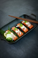 Elegant Salmon Sashimi Bites on a Dark Plate