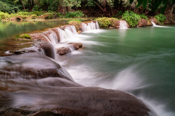 Serene Waterfall Oasis: Captivating scenery of tranquil waterfall gracefully cascades into a calm, reflecting pool, embodying nature's artistry and the essence of peace.