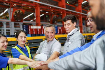 Unity team engineers, workers clasped hands raising together showing teamwork and unity.