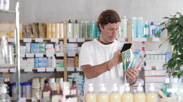 European scans the barcode on the packaging of toothbrushes on a mobile and pays using an online application on a mobile phone. Buyer in a pharmacy pays for purchases by QR. High quality 4k footage