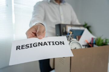 Stressful business men will resign from the company. Working male pass on document resign of...