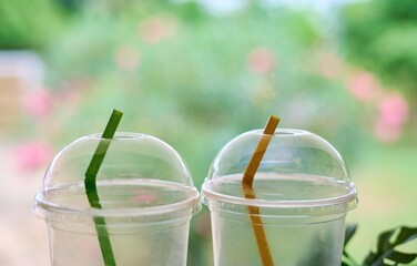 Two Empty Plastic Cups with Colorful Straws