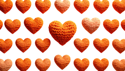 Knitted orange heart pattern on black background, one lighter shade