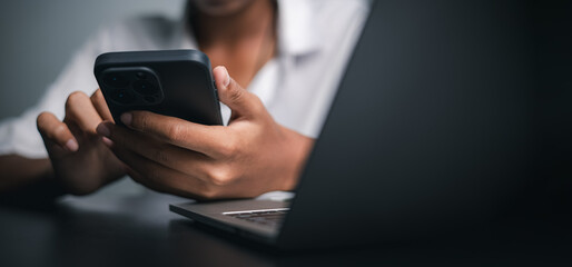 Business Person Using Smartphone and Laptop for Digital Communication