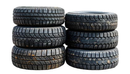 Stack of six used, dark tires with noticeable tread pattern