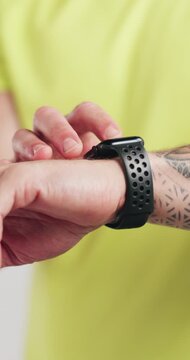 Man, hands and smart watch in studio for workout, tracking heart rate and click fitness progress app. Person, scroll or check time for exercise results, wellness information and monitor step counter.