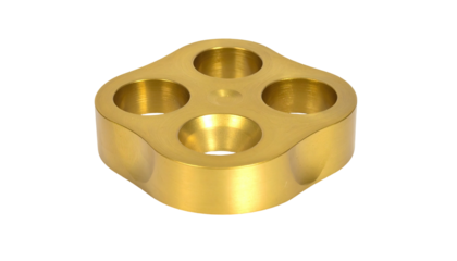 Golden metal block w/ four holes, rounded corners, dark background