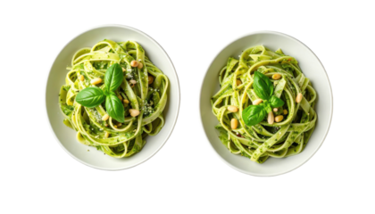 Two bowls of pesto pasta, garnished with pine nuts & basil