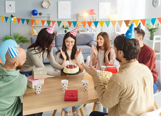Happy birthday party with cake for overjoyed multi ethnic friends group together, smiling diverse...