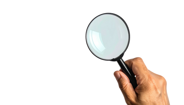 Hand holds magnifying glass against stark black background