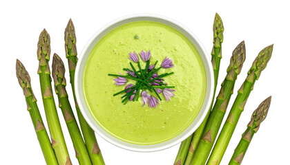 Green soup in bowl, flanked by asparagus spears