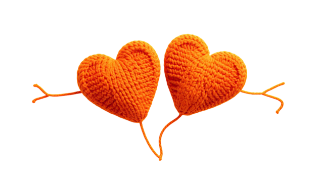 Two orange yarn hearts with yarn arms against black