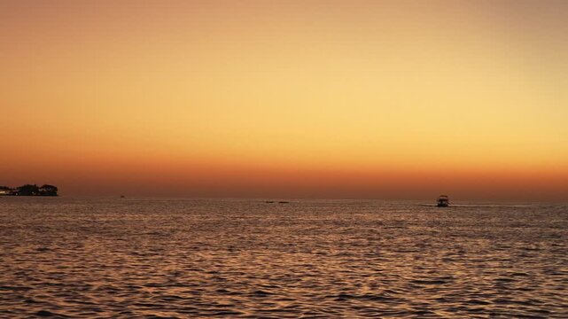 Beautiful stuning sunset,with nice city background,with boat and blue sea
