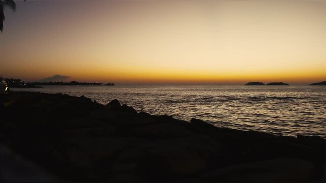 Beautiful stuning sunset,with nice city background,with boat and blue sea