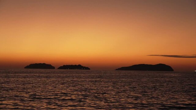 Beautiful stuning sunset,with nice city background,with boat and blue sea
