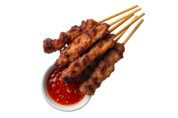 Delicious grilled chicken satay with a chili dipping sauce, a popular Asian appetizer or snack, isolated on transparent background