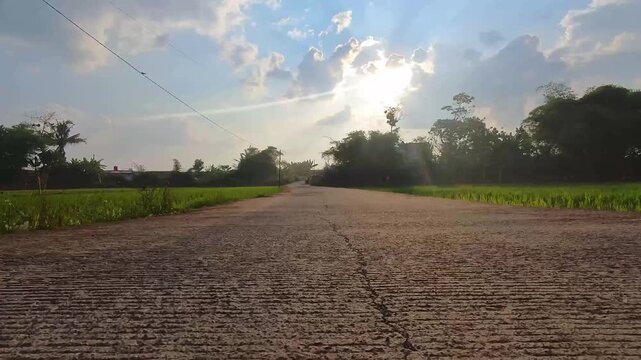 Footage of RC cars with a camera, riding on an empty street with rice paddies on the left and right. Experience the adventure of remote control cars on outdoor roads with low-angle shots in 4K Footage