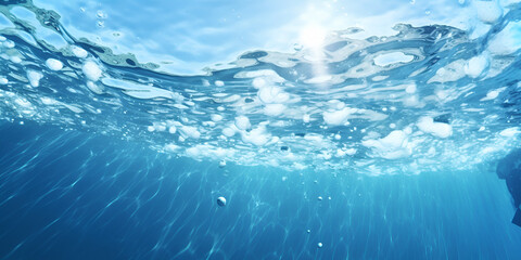 Underwater view of shimmering light and bubbles in vibrant blue ocean, perfect for tranquil scenes