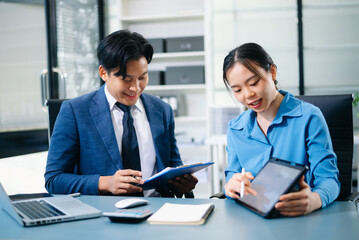 Business people meeting at office writing notes about sticky notes Laptop,tablet Planning and Brainstorming Strategies of Colleagues in office.