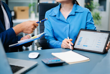 Business people meeting at office writing notes about sticky notes Laptop,tablet Planning and Brainstorming Strategies of Colleagues in office.