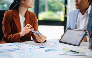 Business people meeting at office writing notes about sticky notes Laptop,tablet Planning and Brainstorming Strategies of Colleagues in office.