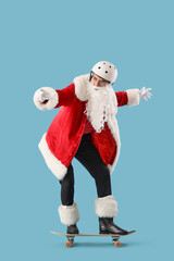 Young Santa Claus in helmet skating on blue background