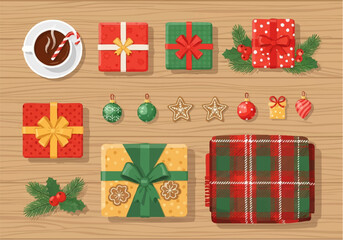 Festive Christmas presents, ornaments, and hot chocolate arranged on a wooden surface.
