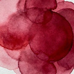 Abstract watercolor painting with overlapping circles in shades of red. Suitable for backgrounds, design elements, and artistic projects.