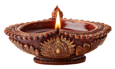 Close-up of a traditional Indian diya lamp, lit with a flame, showcasing intricate details.