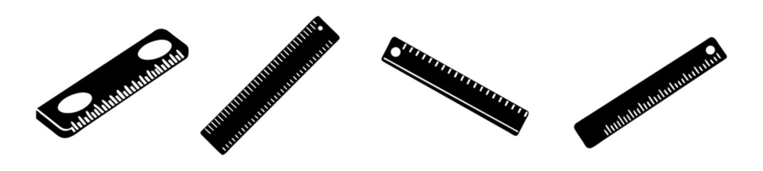 Four black silhouette rulers on a, showcasing measuring tools and drafting equipment