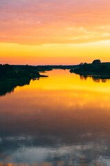 Obraz premium River at Sunset with Reflective Water