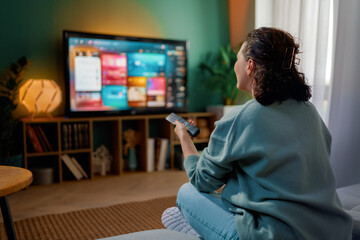 woman watching TV at home