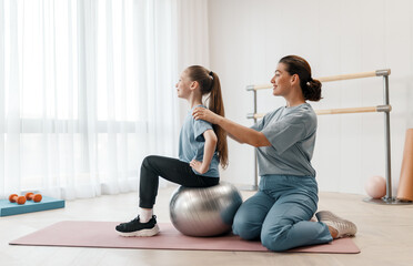 girl doing exercises under doctor's supervision