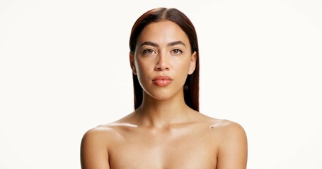 Obraz premium Cosmetics, woman and skincare portrait in studio with natural beauty, healthy glow and hydration. Mockup space, girl or serious with dermatology on white background for collagen treatment or wellness