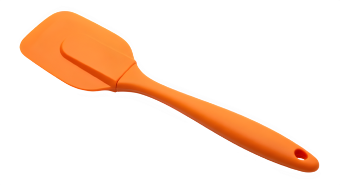 Close up of an orange silicone spatula tool kitchen cooking ware on black background