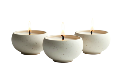 Three lit spherical candles on a dark background