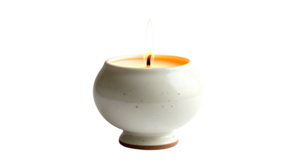 Small, round candle glows in speckled, ceramic holder