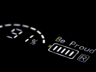 Digital display glows against dark backdrop, showcasing a nearly full battery and positive message.